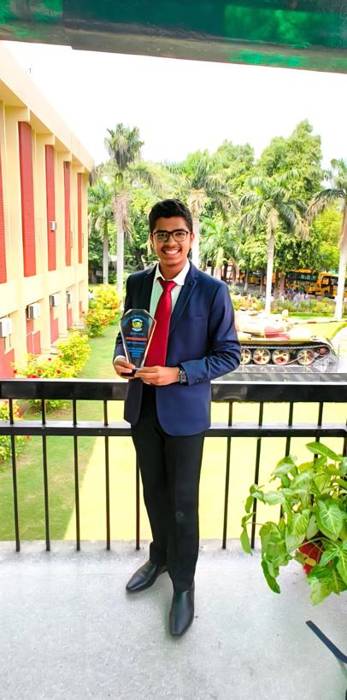 Vedant Agrawal holding an award trophy